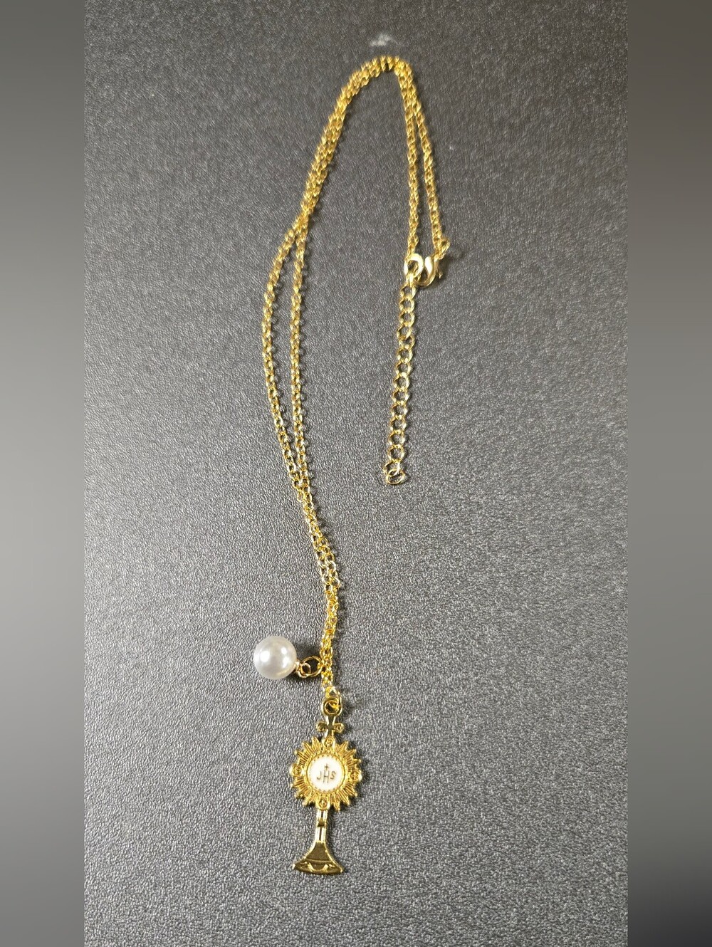 35 region is a gold-tone Catholic Rosary necklace